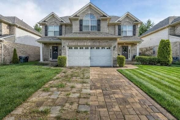 Rental property exterior with a cleaned paver driveway and freshly cut lawn